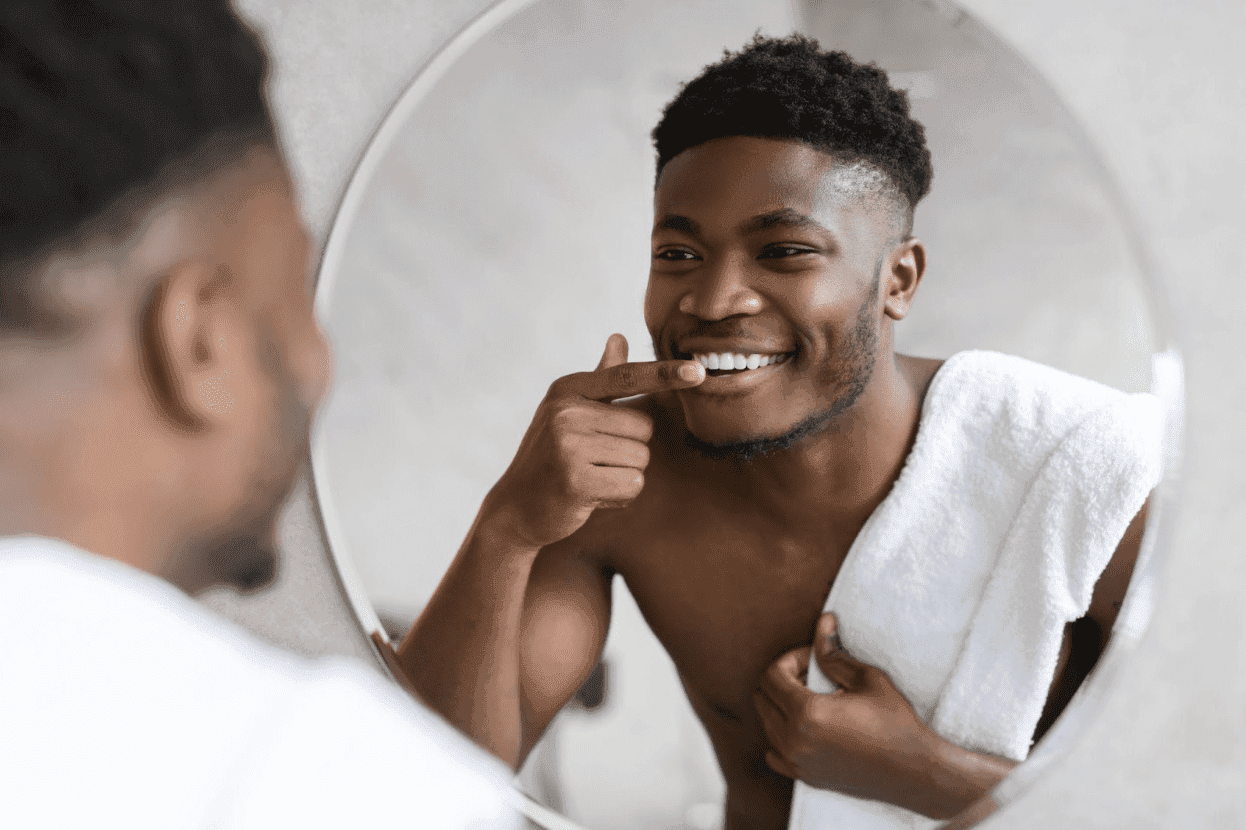 man touching his lips in the mirror